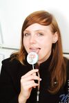 Red Haired Teen Babe Beth Nubiles Slowly Strips While Eating A Lollipop.