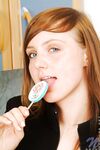 Red Haired Teen Babe Beth Nubiles Slowly Strips While Eating A Lollipop.