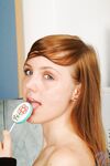 Red Haired Teen Babe Beth Nubiles Slowly Strips While Eating A Lollipop.